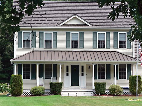 2 story house with porch with metal roofing|2 story house with metal roof.